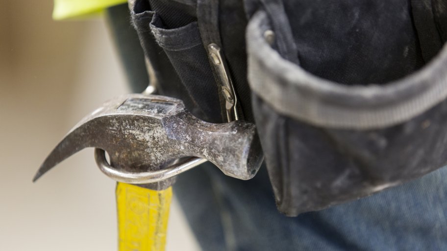 hammer hanging from contractor's toolbelt
